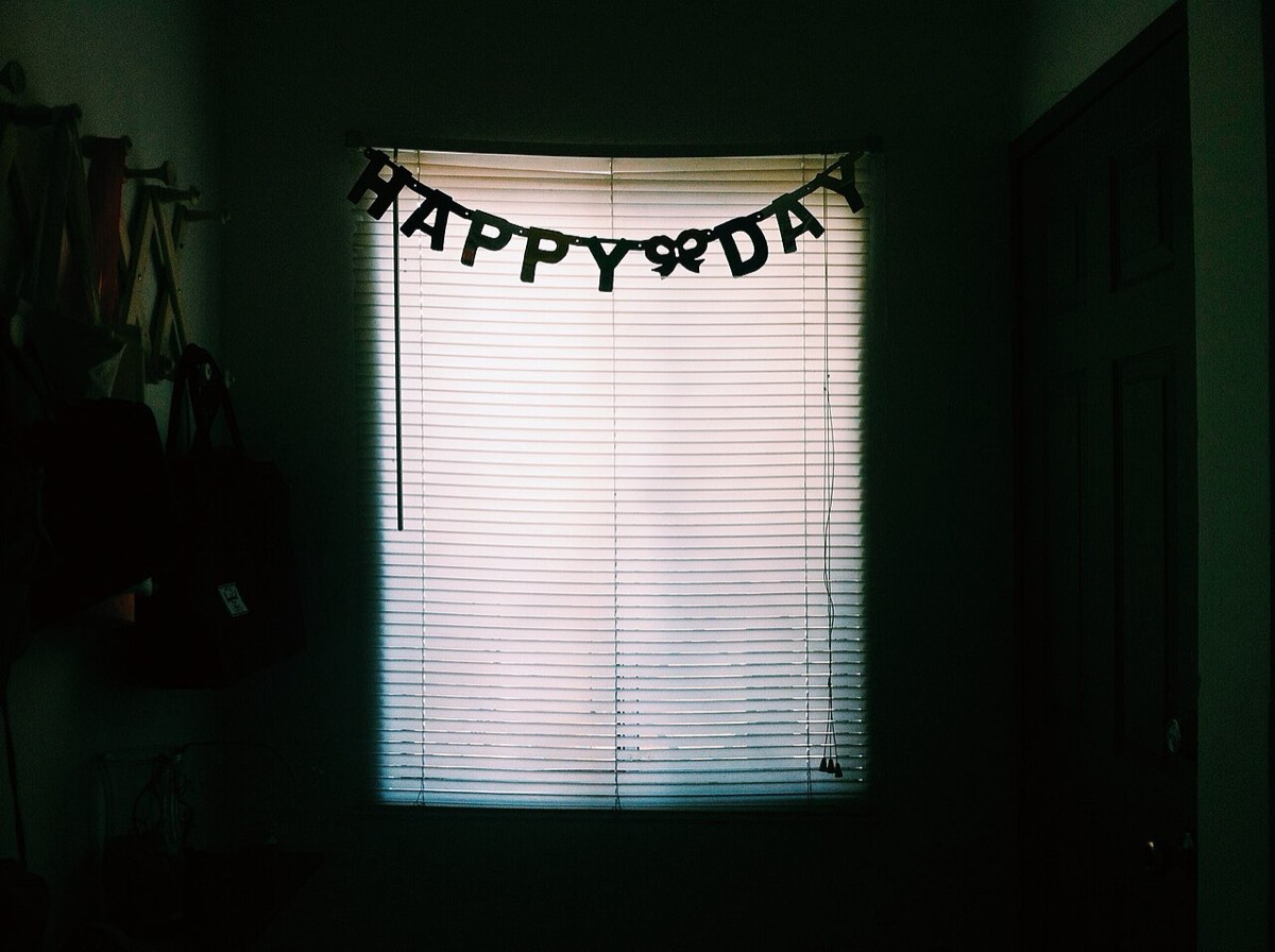 Happy birthday banner hanging in a window