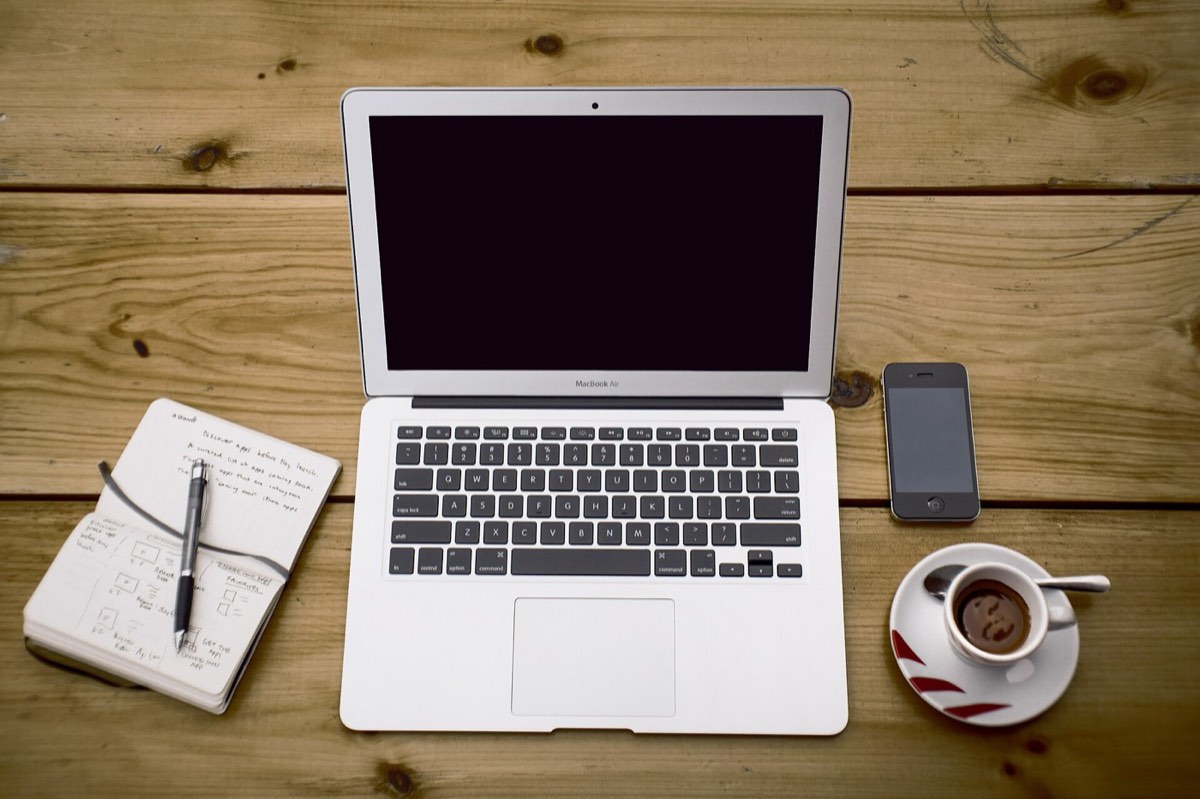 A laptop and phone on a desk: every render runs on paid GPU time