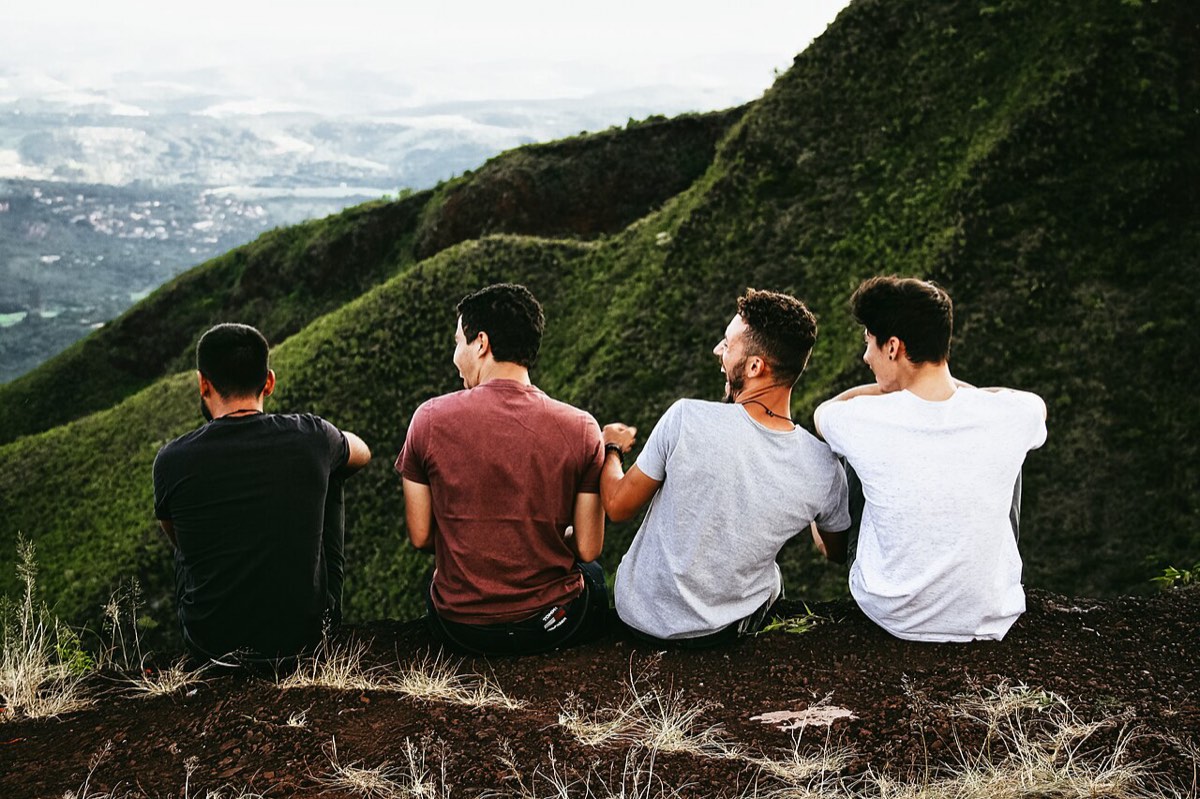 Friends sitting together above a valley