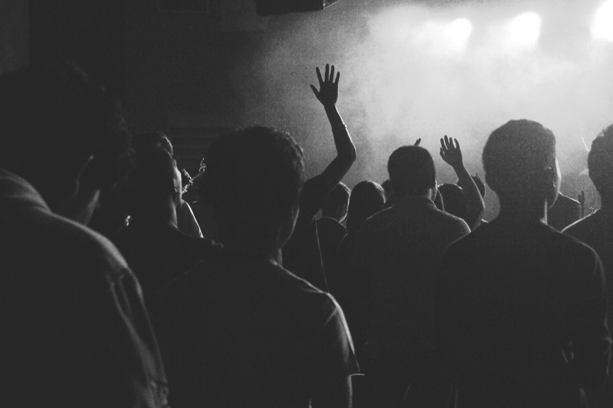 A concert crowd: the composed image puts both people on one shared stage
