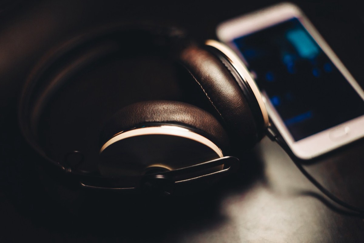 Headphones and a phone: the finished clip is a vertical MP4 with audio