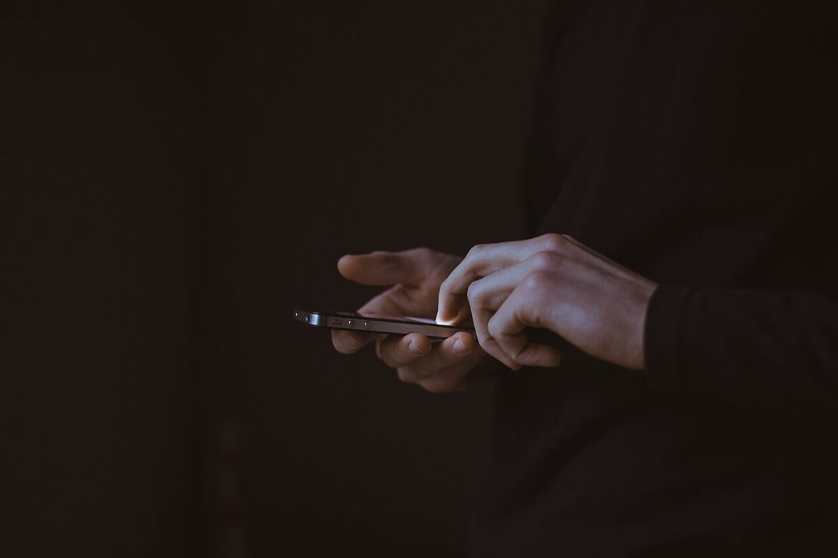 A phone in hand, ready to post